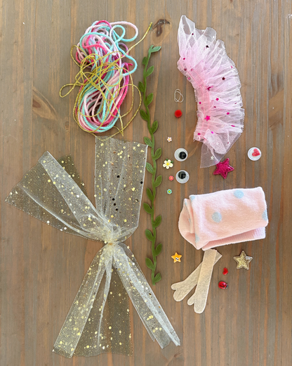 Cheeky the Fairy DIY sock puppet kit materials laid out, including pink sock, fairy wings, tutu, colourful wool and craft decorations